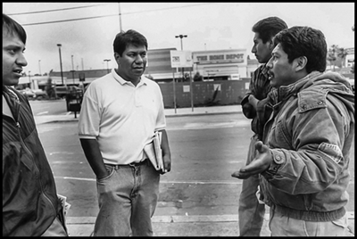 Pablo Alvarado, organizer for the Day Labor Union (and now director of the National Day Labor Organizing Network), talks to a group of day laborers getting work on the corner at Sunset Blvd. in Hollywood.